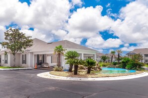 A residential area with houses, a swimming pool, and a landscaped garden.