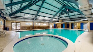 An indoor swimming pool with a high ceiling and visible structural beams. - Gulfview condo wbalcony & resort amenities - shared pools, hot tubs, tennis (Gulf Shores)