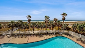 A pool area with lounge chairs and a view of the beach. - Updated Gulf front condo w/ shared pool, hot tub, and sauna, & beach access (Orange Beach)