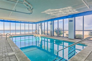 An indoor swimming pool with clear views of the beach, large windows, and a tiled floor. - Amazing Condo in Gulf-Front w/Free WiFi, Shared Pool & Hot Tub, Central AC (Orange Beach)