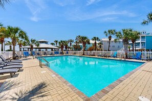 A swimming pool with lounge chairs, palm trees, and a gazebo. - Family-friendly beach home w Gulf views, a full kitchen, & spacious living area (Orange Beach)