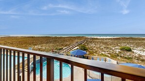 A pool area with a view of the beach and ocean. - Waterfront condo w/ balcony, multiple pools, lighted tennis courts, hot tub (Orange Beach)
