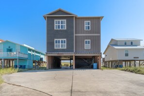 A two-story building with a garage entrance, numbered 2093, and a clear sky above. - Delightful escape with direct beach access, WiFi, furnished deck, & full kitchen (Gulf Shores)