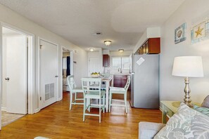 A compact living space with a kitchenette, dining area, and a small seating area. - Lakeview Condo with Shared Pool - Just Steps from the Beach! (Gulf Shores)