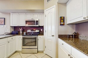 Fridge, microwave, oven, stovetop - Beachfront condo with shared pool, outdoor shower, and beach access (Gulf Shores)