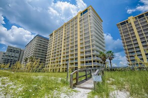A multi-story hotel with balconies, a beach view, and a sign indicating it is a summer house for guests. - Dreamy beach condo with water views, balcony, pool & beach access (Orange Beach)