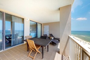 Outdoor dining - Large beachfront condo with views from private balcony and shared hot tub & pool (Orange Beach)