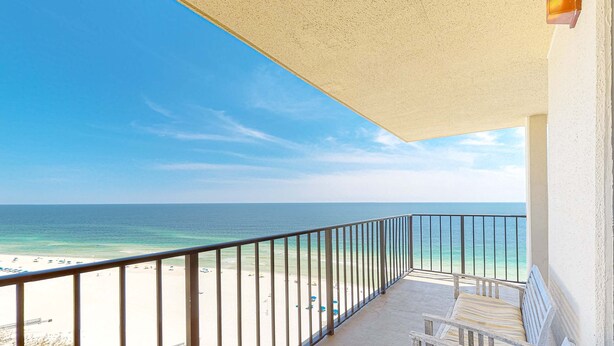 A balcony with a view of a beach and ocean. - Gulf-front fourteenth-floor condo with pools, hot tub & great view (Orange Beach)