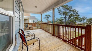 A wooden deck with a railing, a bench, and a view of the beach and ocean. - Gulfview duplex with panoramic views, large balcony, and internet (Dauphin Island)