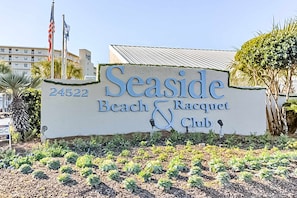 A sign for Seaside Beach & Racquet Club with a number 24522. - Seaside escape with balcony, WiFi, pools, tennis, steam room, & gym (Orange Beach)