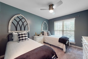 A bedroom with two beds, a ceiling fan, a window with blinds, and a dresser. - Seven Rings, Dog-friendly house with back patio, grill, streaming, washer,dryer (Dauphin Island)