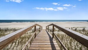 A wooden boardwalk leading to a beach with a clear sky. - Gulf front home with private dune walk over, internet, & washer & dryer (Dauphin Island)