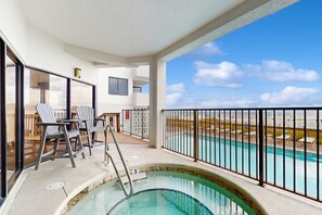A pool area with a view of the landscape, a pool with a number 3 sign, and lounge chairs. - Gulf-front 6th-floor condo with balcony, pool, hot tub, & sauna - beach access (Orange Beach)