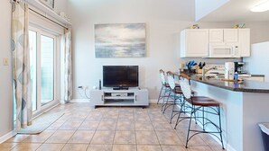 A modern kitchen with white cabinets, a microwave, and a coffee maker. - Spacious condo near the beach with great view, bonus loft, and shared pool (Orange Beach)