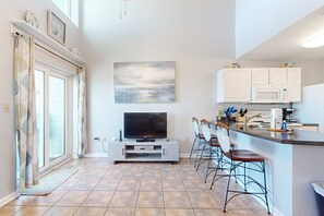 A modern kitchen with white cabinets, a microwave, and a coffee maker. - Spacious condo near the beach with great view, bonus loft, and shared pool (Orange Beach)