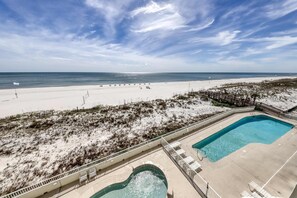 A beach view with a pool area, including a rectangular pool and a smaller circular pool. - Recently Updated Beachfront Condo w/ Incredible Views Plus Shared Pools, Hot Tub (Orange Beach)