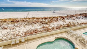 A beach view with a swimming pool and a fence. - Waterfront condo w/ a private balcony, community pools, & fitness center (Orange Beach)