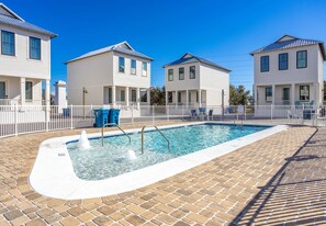 A swimming pool with a brick deck, surrounded by white fences and houses. - Friendly home with private pool, WiFi, private washer,dryer, and central AC (Orange Beach)