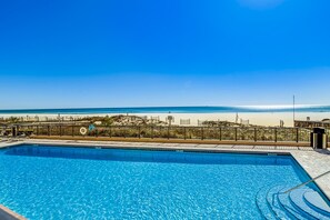 A swimming pool with a view of the beach and ocean. - Delightful Corner Getaway With Gulf Views, Beach Access, Free WiFi & Shared Pools (Orange Beach)