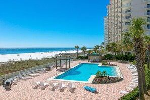 A pool area with lounge chairs, a small pool, and a view of the beach. - Lovely resort condo with spectacular Gulf views, pool & tennis (Orange Beach)