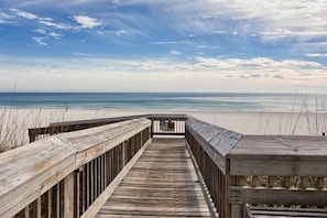 A wooden boardwalk leading to a beach with a clear view of the ocean. - Fifth-Floor Getaway in Beachfront Resort with Free WiFi, Central AC, Shared Pool (Orange Beach)