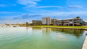 Ein Hotel am Wasser mit mehreren Gebäuden, einem Steg und ruhigem Gewässer.