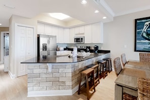 Fridge, microwave, oven, stovetop - Lovely Gulf-front condo with pool, sauna, washer dryer, & central AC (Gulf Shores)
