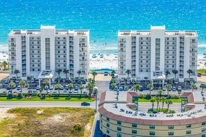 Ein Küstenhotel mit mehreren Hochhäusern, einem Parkplatz und einem Strand im Hintergrund.