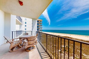Outdoor dining - Beachfront condo with Gulf-view balcony, W/D, pools, hot tub, tennis, & gym (Orange Beach)