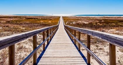 Ground-floor condo next to on-site pool with private patio & beach access