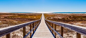 Ground-floor condo next to on-site pool with private patio & beach access