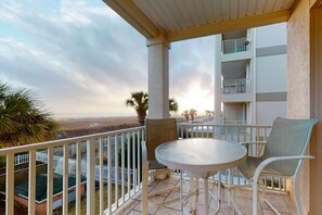 Outdoor dining - Newly -renovated waterfront condo w/two full kitchens, deck, WiFi, & shared pool (Dauphin Island)
