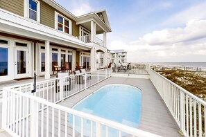 A multi-story hotel with a swimming pool, balconies, and a view of the beach. - Large and Beautiful Beachfront Home with Private Pool, Central AC (Gulf Shores)