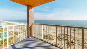 A balcony with a view of the beach and ocean. - Beachfront Balcony with Million-Dollar Views, Shared Pool, WiFi, Washer & Dryer (Gulf Shores)