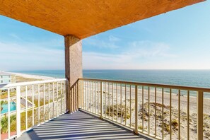 A balcony with a view of the beach and ocean. - Beachfront Balcony with Million-Dollar Views, Shared Pool, WiFi, Washer & Dryer (Gulf Shores)