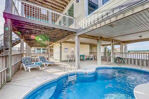 A pool area with lounge chairs, a covered deck, and a view of the surrounding landscape. - Dog-Friendly & Attractive Beach House w/Private Pool, Free WiFi, Central AC (Gulf Shores)