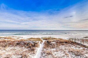 A beach with a sandy path leading to the water, a wooden fence, and a clear sky. - Dog-Friendly & Attractive Beach House w/Private Pool, Free WiFi, Central AC (Gulf Shores)