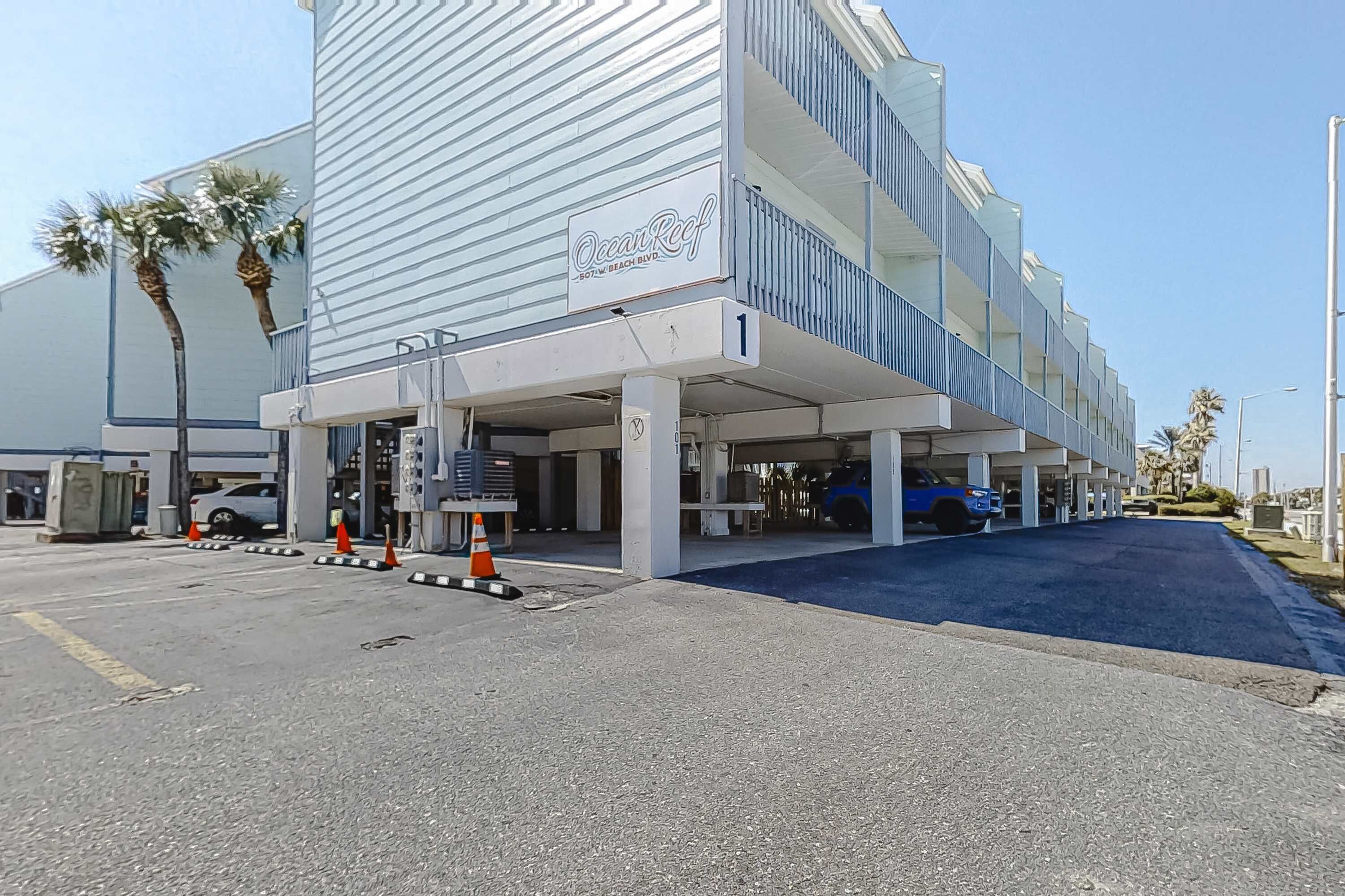 A multi-story building with a sign reading 'Ocean Reef.'