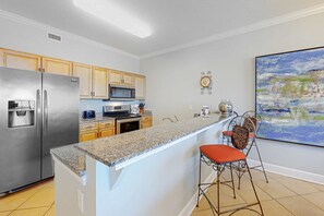 Fridge, microwave, oven, stovetop - Sunny, oceanfront condo with balcony, pool, hot tub, gym, sauna & view (Orange Beach)