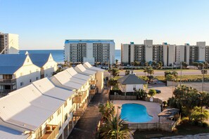 A hotel with multiple-story buildings, a swimming pool, and a view of the ocean. - Coastal escape with 2 water-view balconies, 2 pools, tennis & beach access (Orange Beach)