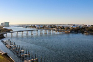 A river with a bridge and docks. - Coastal escape with 2 water-view balconies, 2 pools, tennis & beach access (Orange Beach)