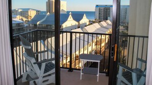 A balcony with a view of the ocean and buildings. - Coastal escape with 2 water-view balconies, 2 pools, tennis & beach access (Orange Beach)