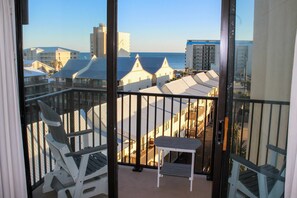 A balcony with a view of the ocean and buildings. - Coastal escape with 2 water-view balconies, 2 pools, tennis & beach access (Orange Beach)