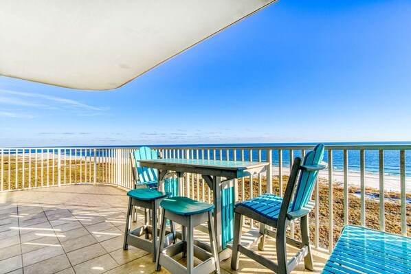 Outdoor dining - Beachfront vacation home with spacious balconies, beach access, pools & hot tub (Orange Beach)