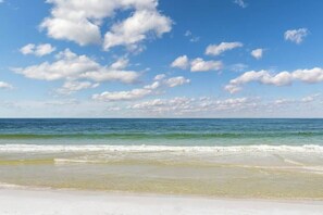 A beach with clear skies and calm water. - Gulf view condo w/ a full kitchen, private balcony, shared pools, & tennis court (Orange Beach)