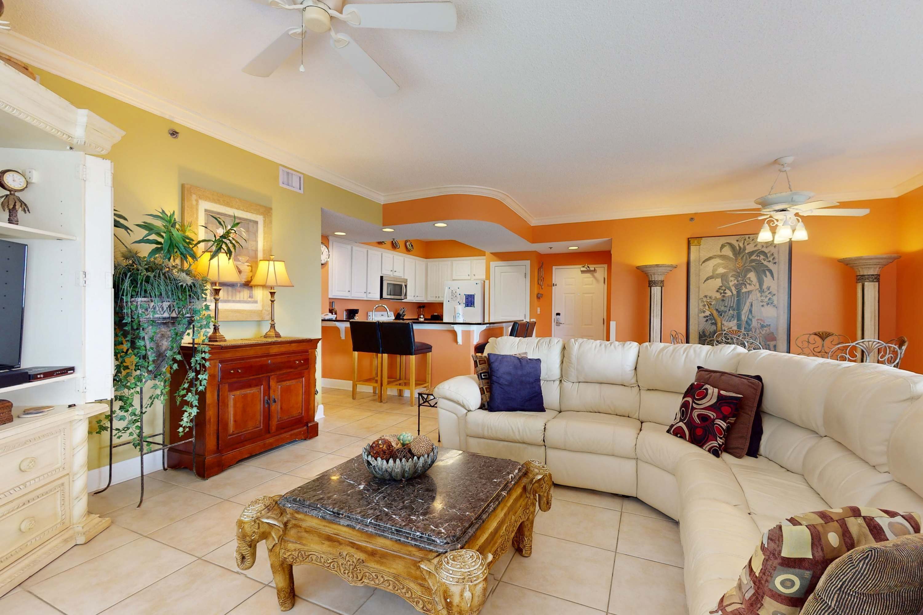 A living room with a sofa, a coffee table, and a TV.