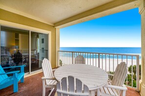 Outdoor dining - Beachfront condo with Gulf front shared pool, private balcony, and grilling area (Orange Beach)