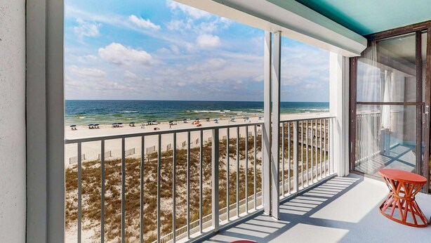 A balcony with a view of the beach and ocean. - Updated, Gulf front condo with beautiful views, shared pool, sauna, and hot tub (Orange Beach)