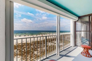 A balcony with a view of the beach and ocean. - Updated, Gulf front condo with beautiful views, shared pool, sauna, and hot tub (Orange Beach)