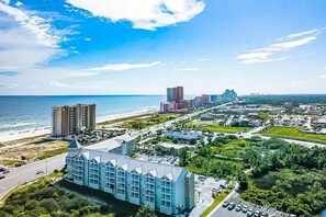 Exterior - Second floor condo with Gulf view, shared pool, central AC, & BBQ area (Orange Beach)
